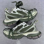 Front view pair of chunky sneakers with green laces, white and silver mesh panels