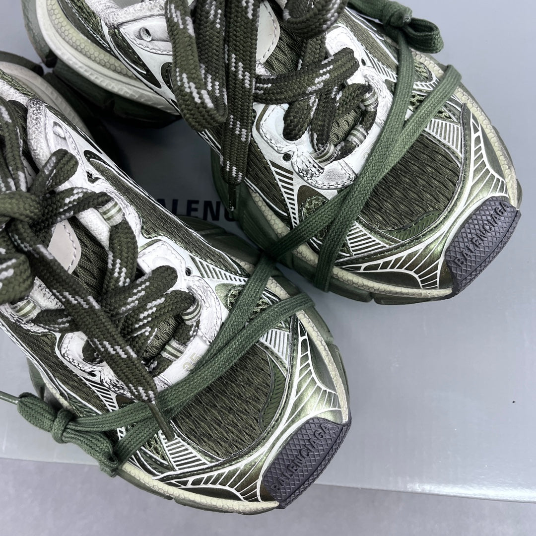 Detailed view of sneakers: green laces over patterned mesh and white logo-style panels