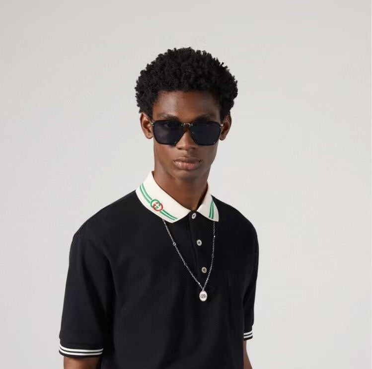 Silver pendant necklace on model with polo collar