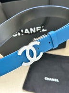 Blue leather belt with large silver CC emblem and metal buckle