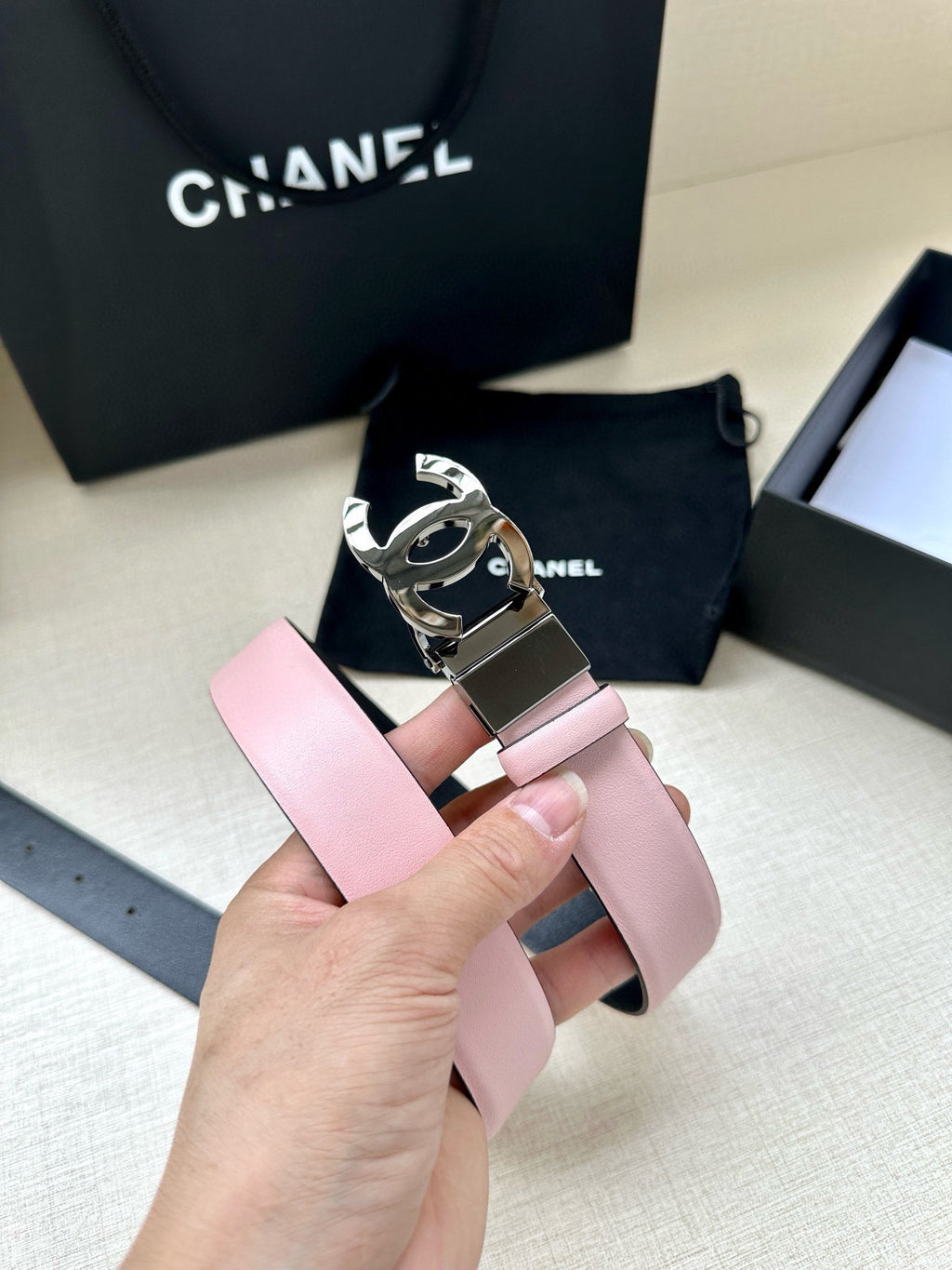 Chanel belt with pale pink strap and silver buckle with CC emblem
