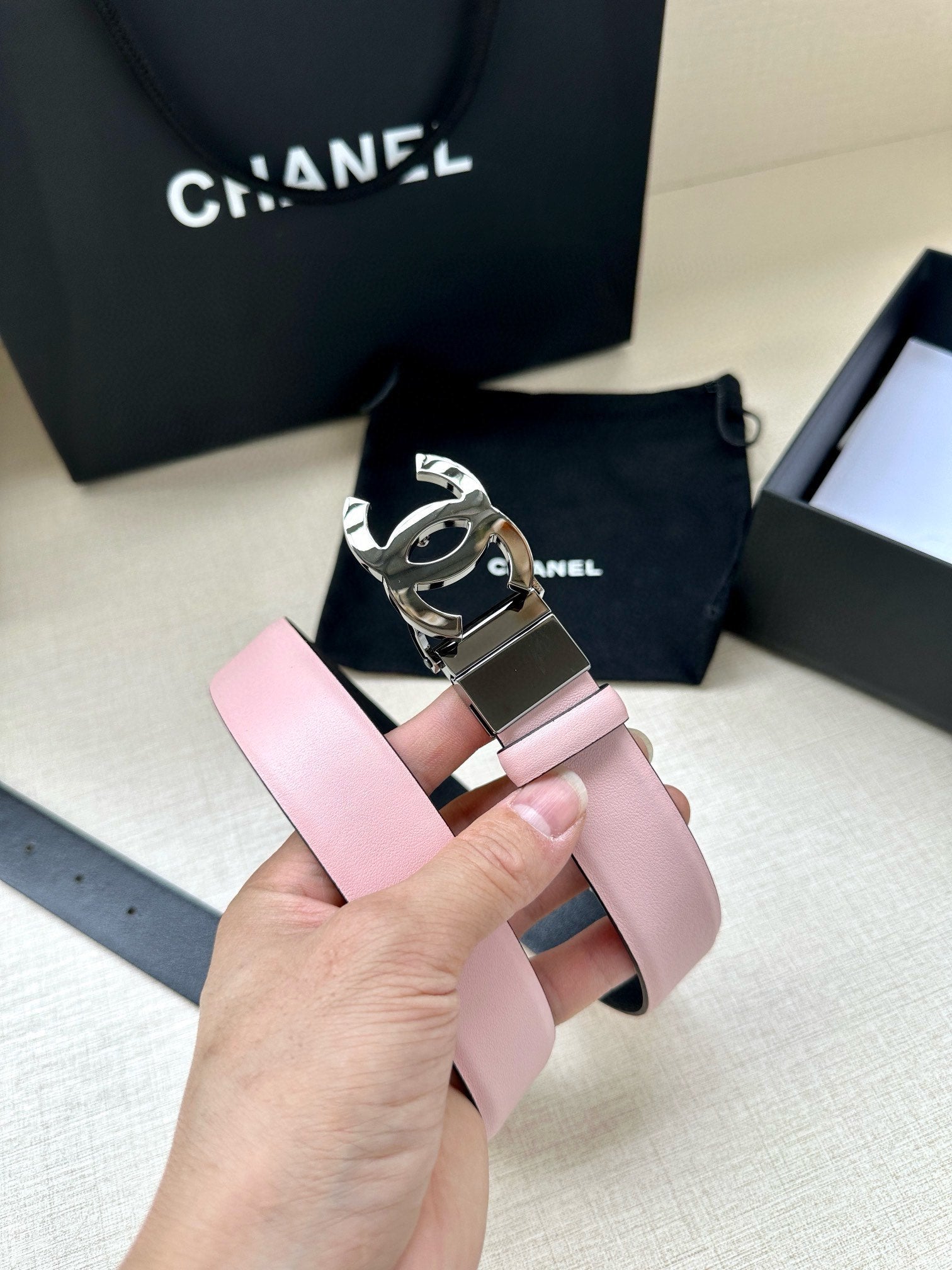 Chanel belt with pale pink strap and silver buckle with CC emblem