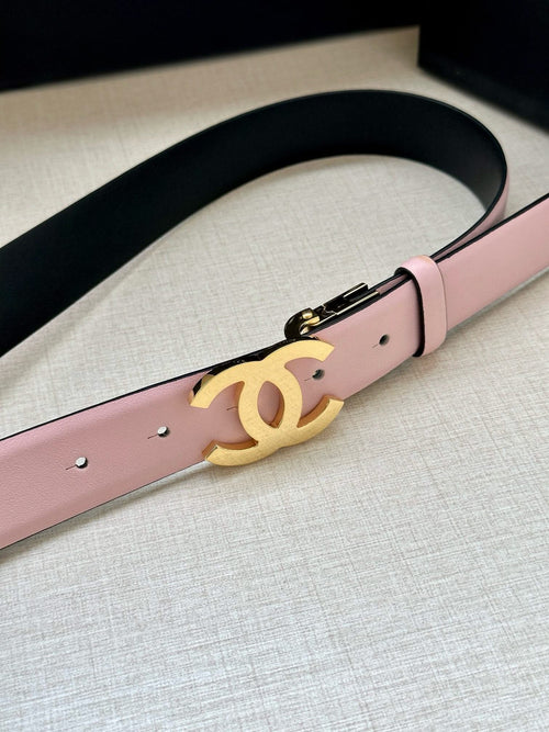 Chanel belt with pale pink strap and gold CC logo centered on the buckle