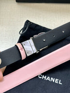 Chanel belt close-up with pale pink strap and silver-tone buckle on dark lining