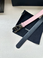 Chanel belt with pale pink strap and silver CC logo buckle on dark underside