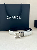 White leather Chanel belt with silver CC buckle on flat lay
