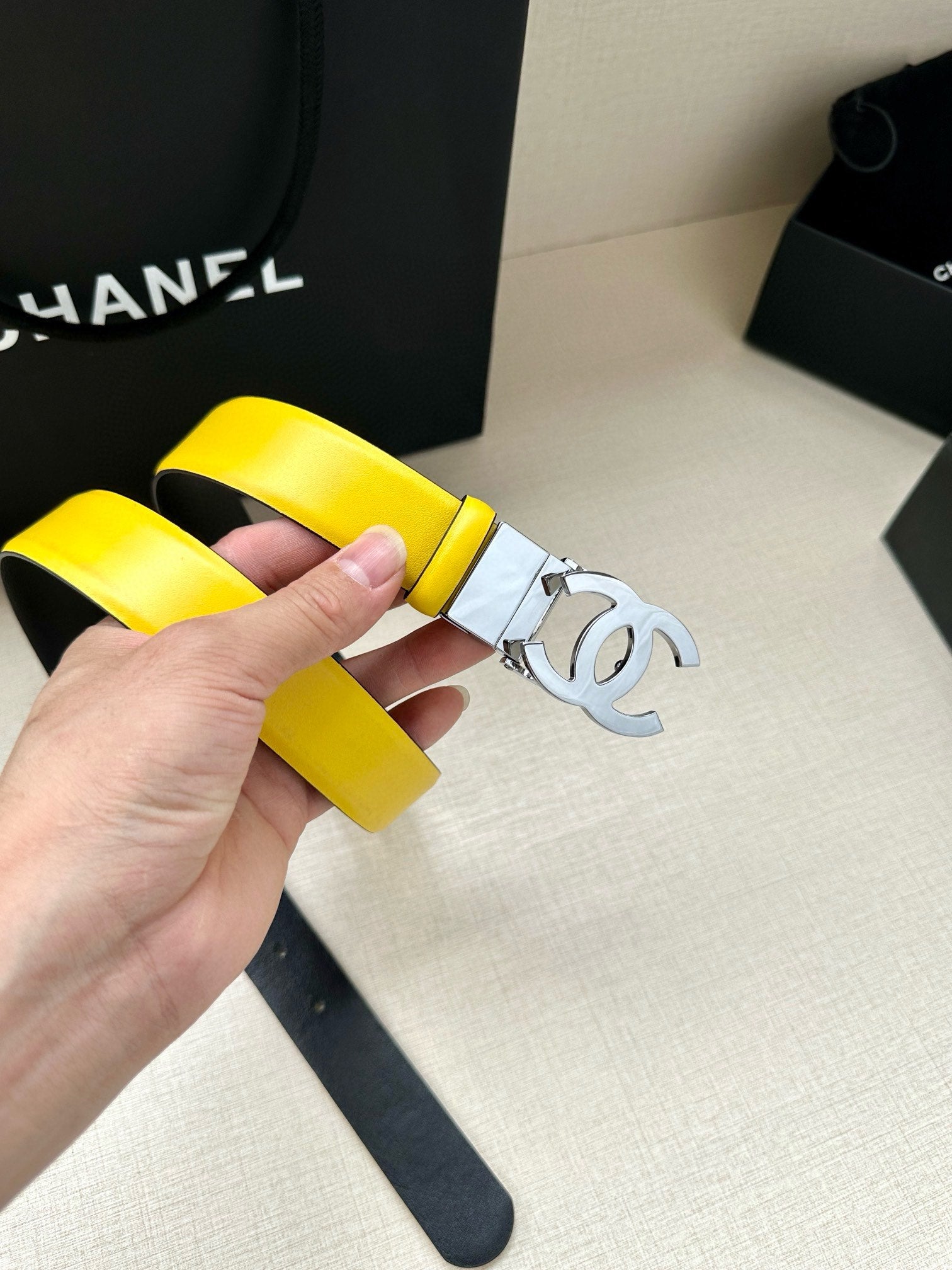 Yellow leather belt with metal Chanel logo buckle and strap keeper