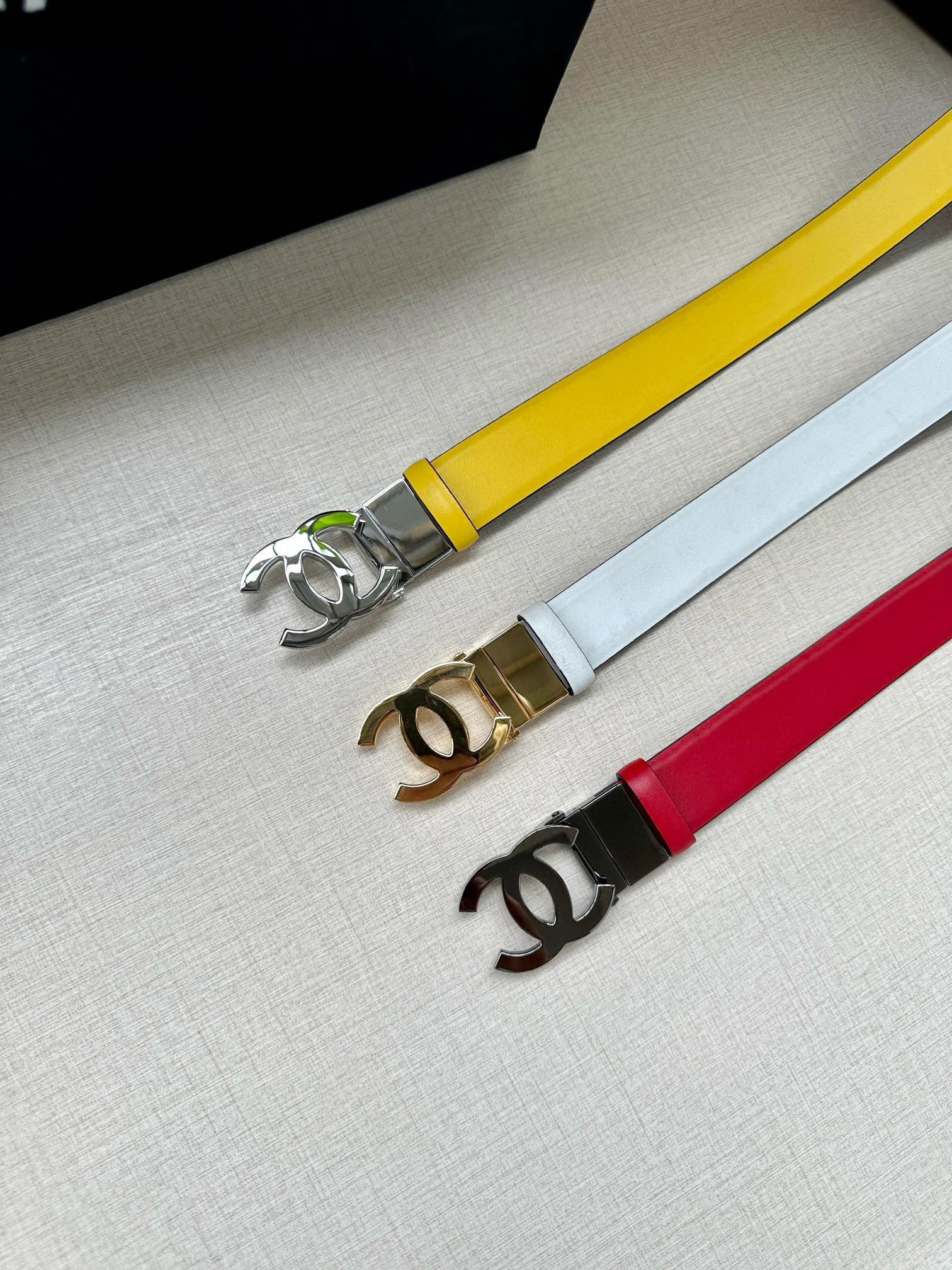 Set of three leather belts: yellow, white, and red, each with Chanel logo buckle