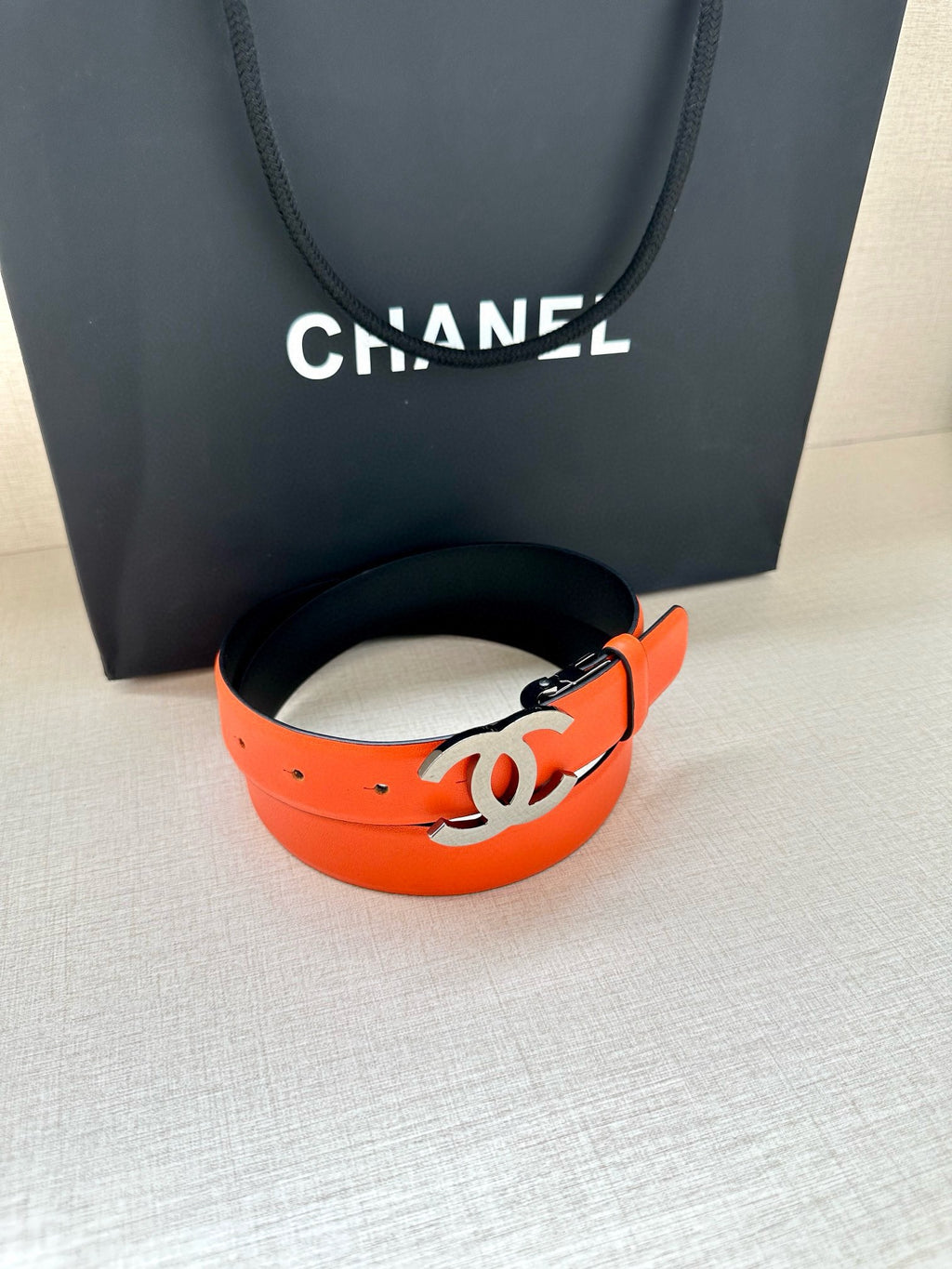Chanel orange leather belt with silver CC logo buckle and adjustable holes