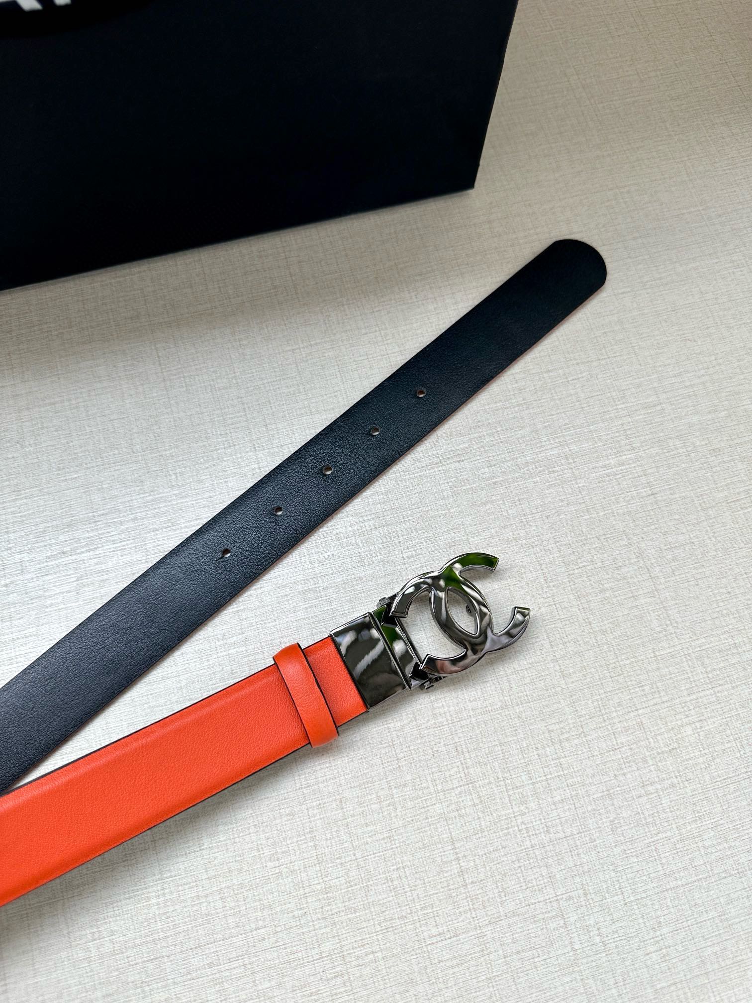 Chanel belt with orange leather center, silver buckle on dark strap