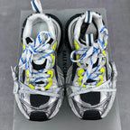 Balenciaga unisex sneakers pair on box, silver uppers, blue-and-neon lace detail