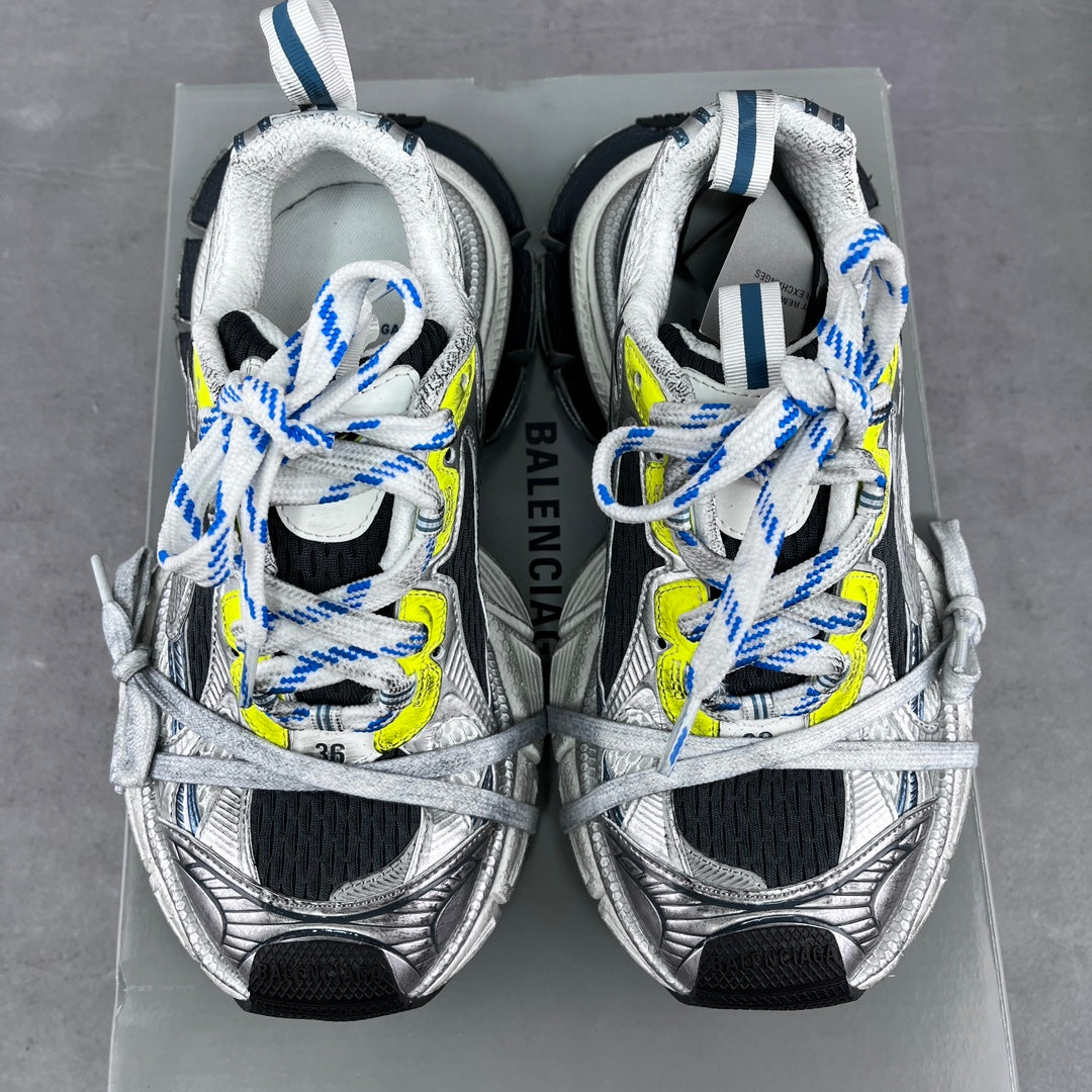Balenciaga unisex sneakers pair on box, silver uppers, blue-and-neon lace detail