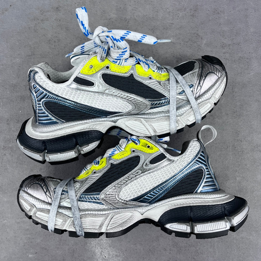 Balenciaga unisex sneakers pair, silver upper with black trim, neon yellow accents, blue laces
