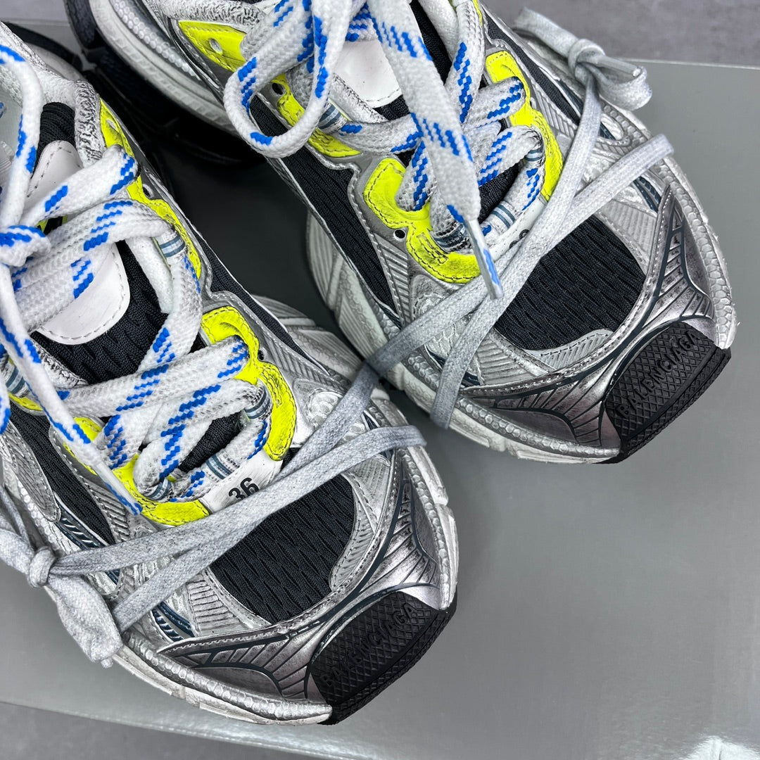 Balenciaga unisex sneaker side view, silver and black panels with neon yellow accents