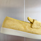 Prada suede loafers in bright yellow/gold, close-up side panel and low sole edge