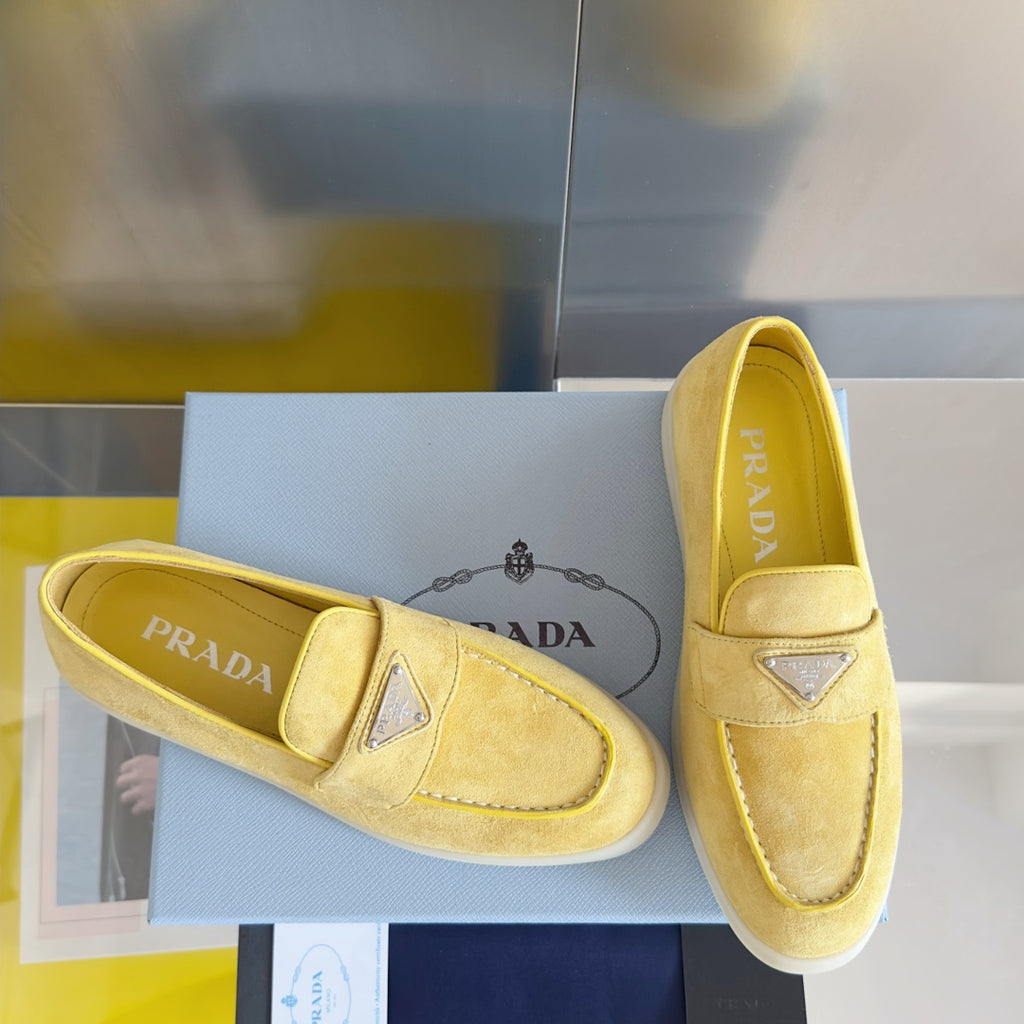 Prada suede loafers in bright yellow/gold, with diamond logo trim and stitched seams