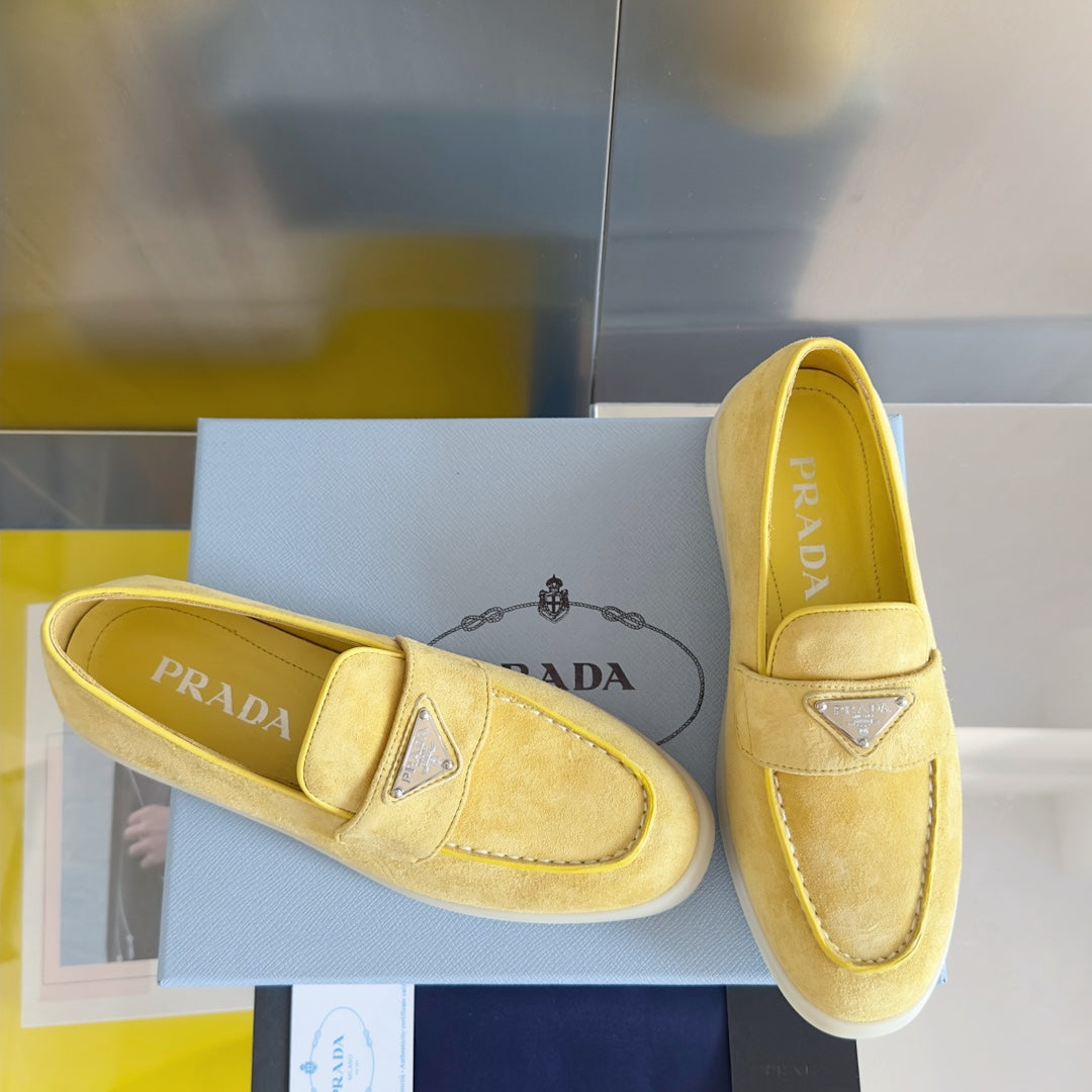 Prada suede loafers in bright yellow/gold, with diamond logo trim and stitched seams