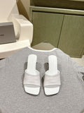 White slide sandals with crossover straps and embossed Balenciaga logo, pair view