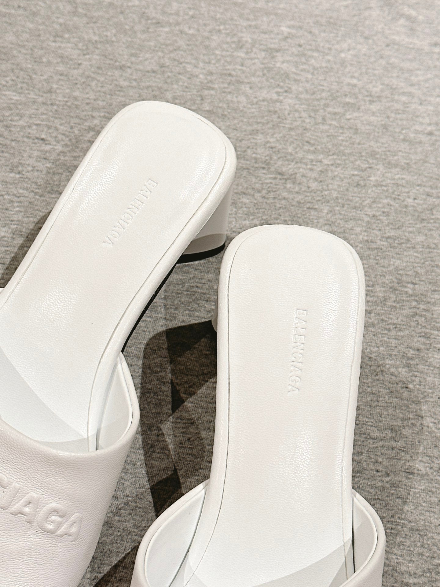 White slide sandal close-up of footbed and embossed lettering on insole