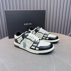 Leather sneakers in white with navy overlays, black laces, blue zipper detail, on box