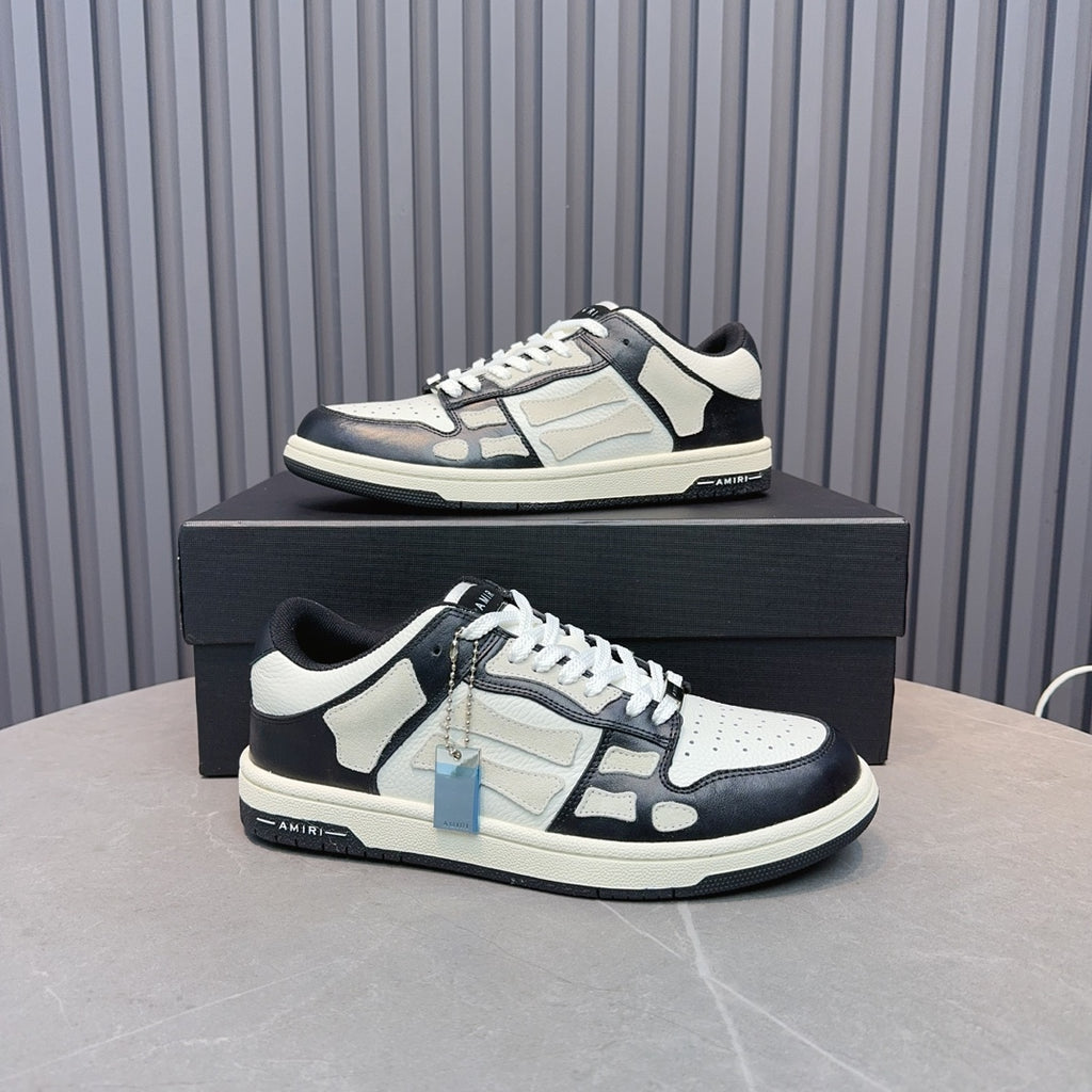 Low-top leather sneakers with white and navy panels, black laces, blue zipper accent