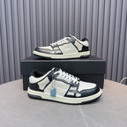 Low-top leather sneakers with white and navy panels, black laces, blue zipper accent