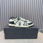 Leather sneakers with white uppers, navy panels, black laces, blue zipper detail