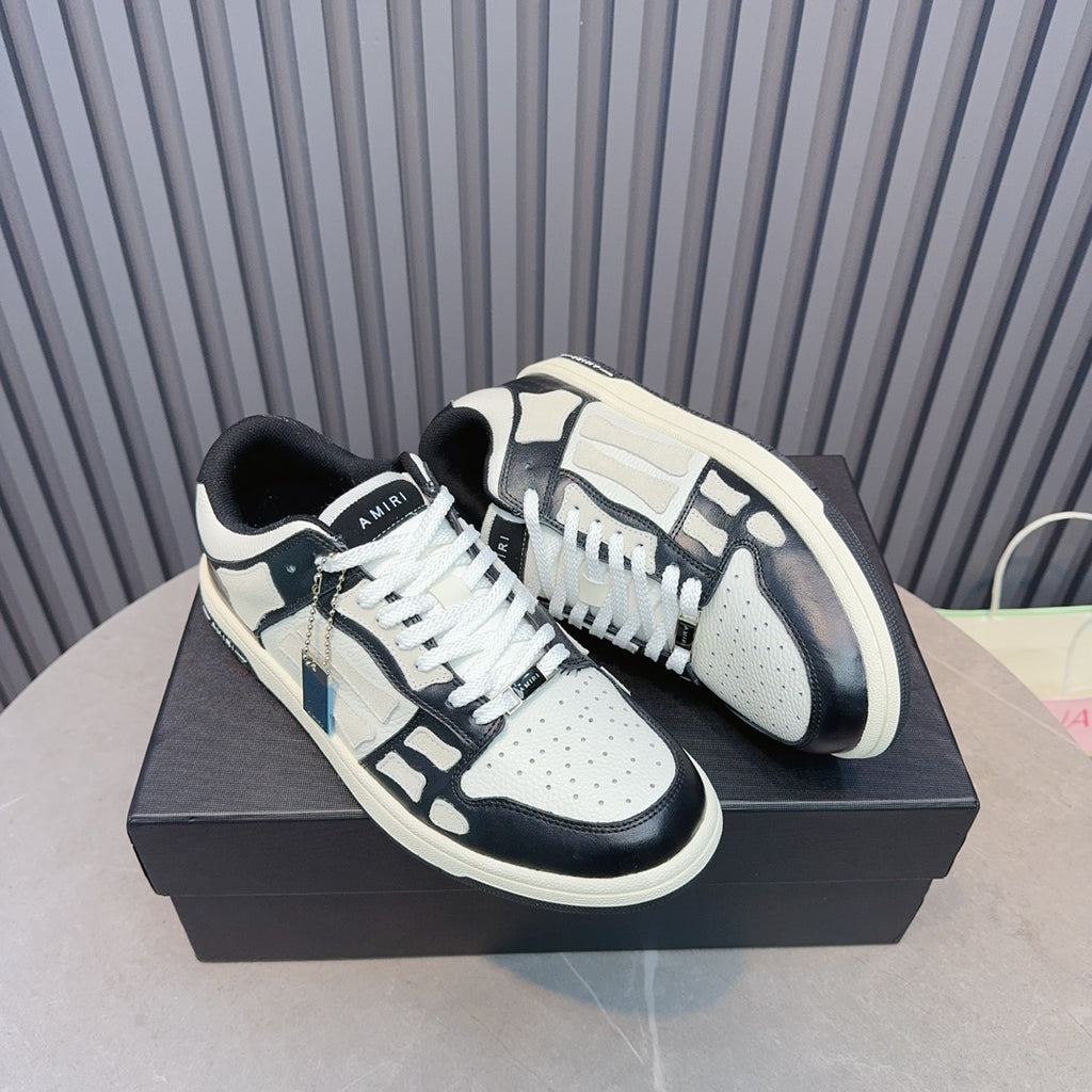 Pair of leather sneakers, white uppers with navy overlays, black laces, blue tag detail