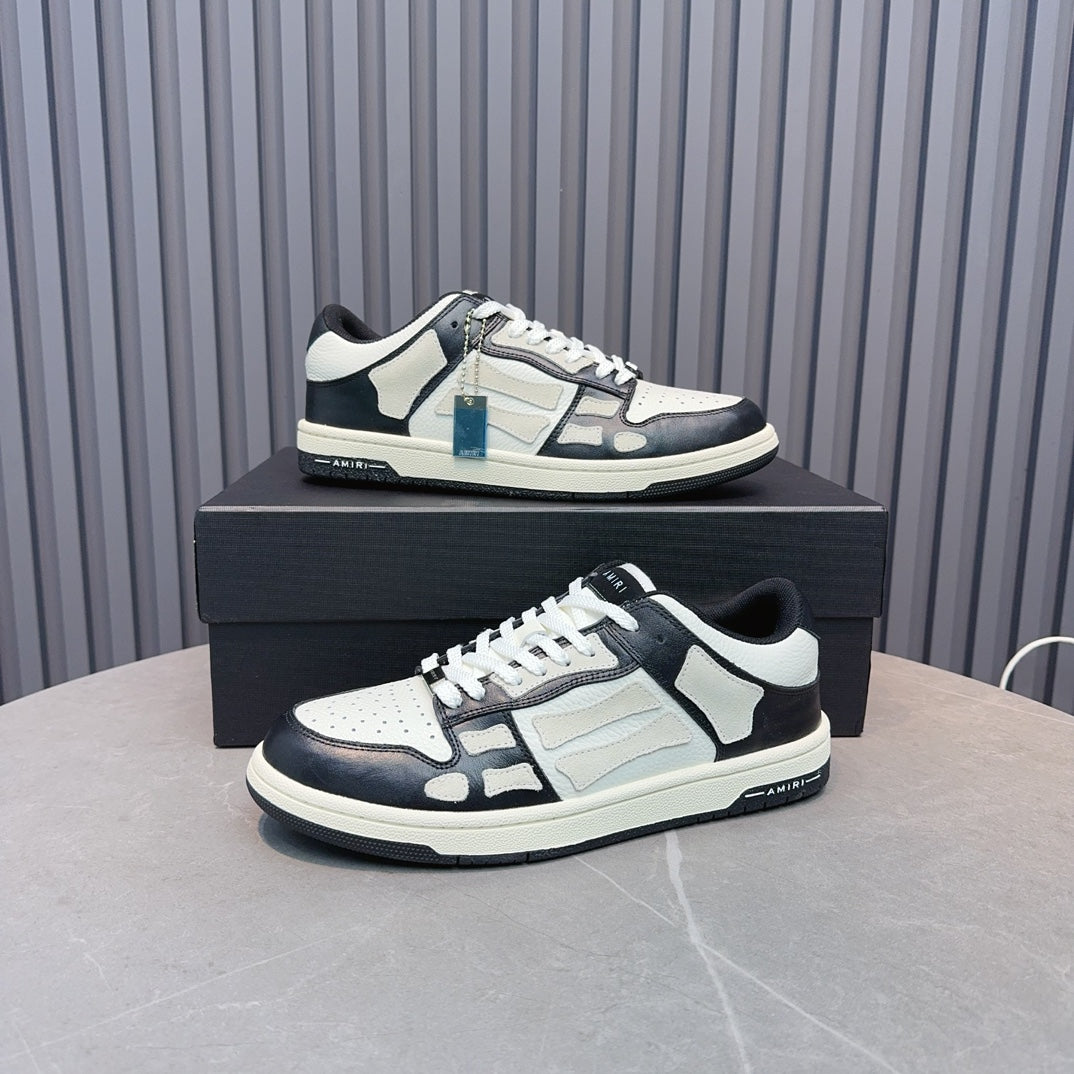 Leather low-top sneakers with white uppers, navy panels, black laces, blue zipper detail