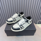 Leather sneakers with white uppers, navy toe and side panels, white laces, blue tag detail