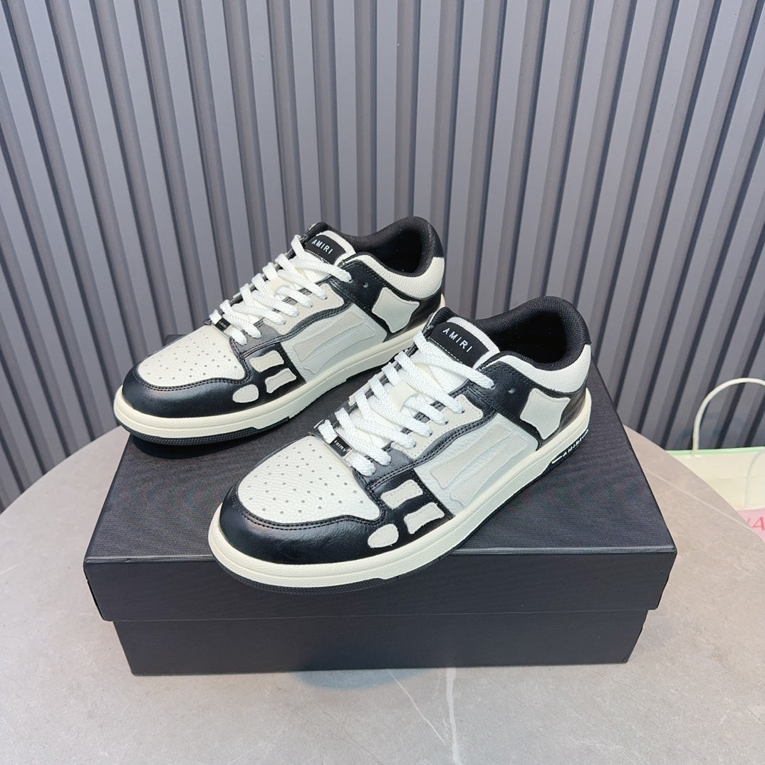 Leather sneakers with white uppers, navy toe and side panels, white laces, blue tag detail
