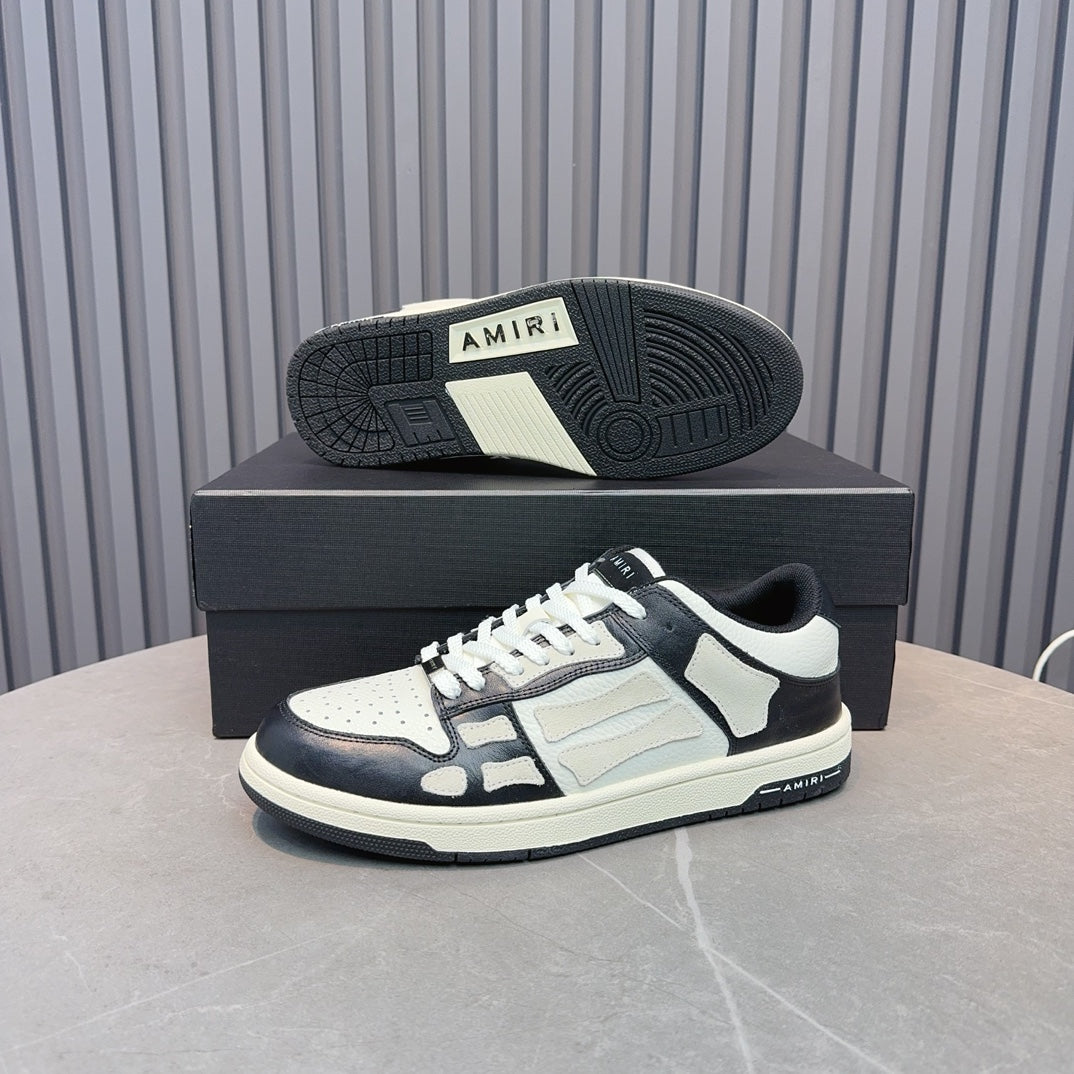 Leather sneakers with white uppers and navy overlays, white laces; rubber outsole visible