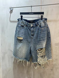 Balenciaga denim shorts with distressed rips and frayed hem, light blue wash