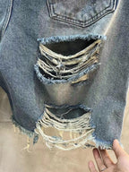 Balenciaga denim shorts with ripped front panels and frayed edges, light blue