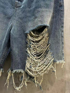 Balenciaga denim shorts with large distressed panel and frayed edges, light blue