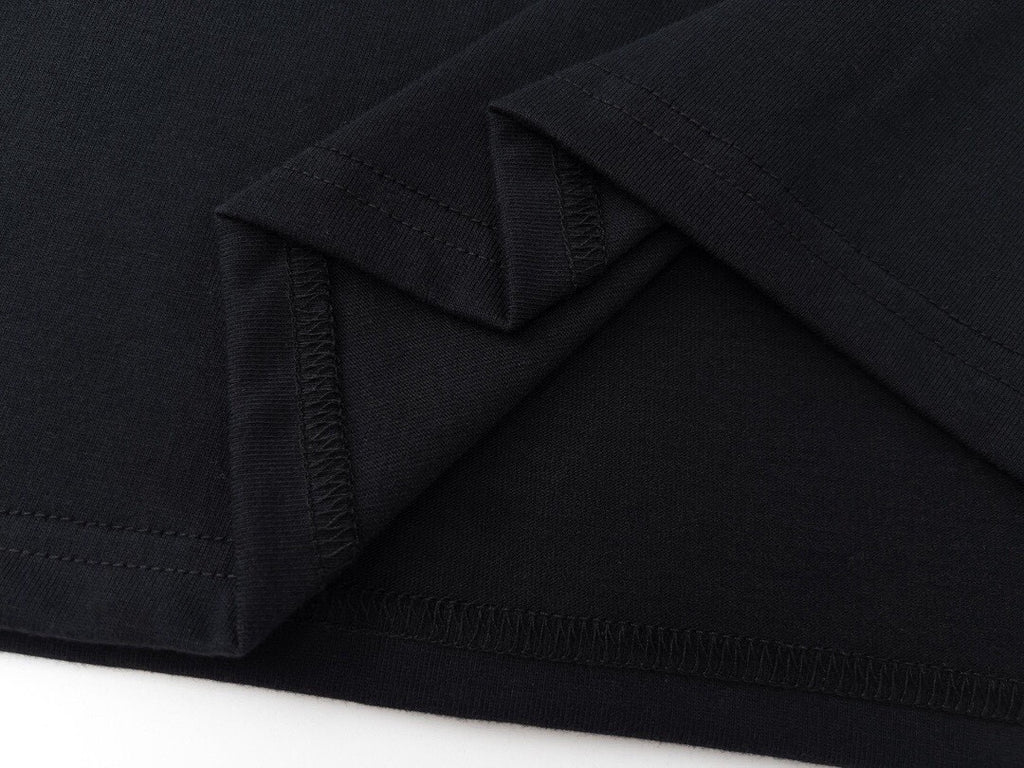 Stone Island T-shirt hem and side seam close-up, dark fabric stitching