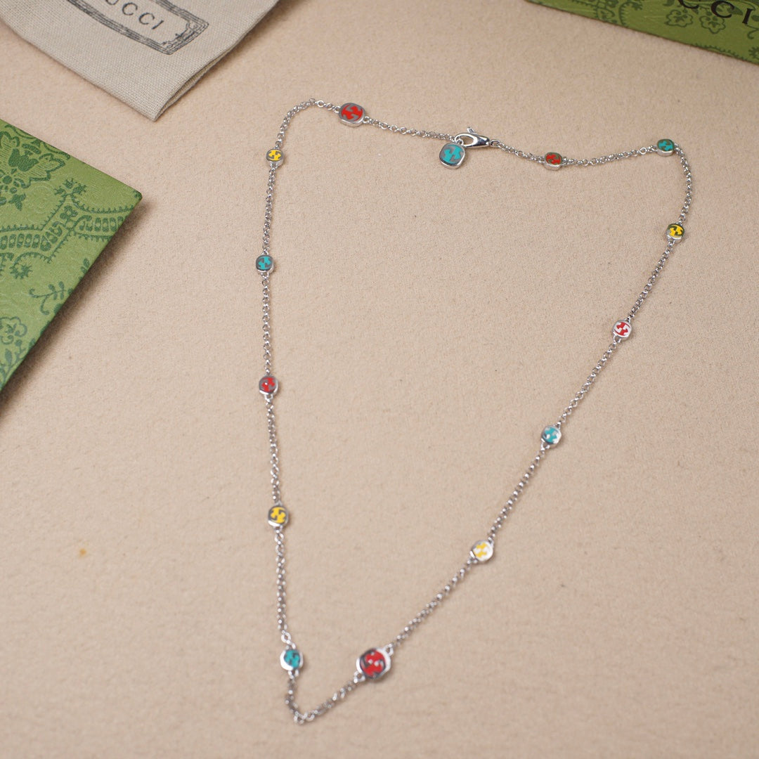 Gucci charm bracelet with silver chain and multicolor enamel round charms