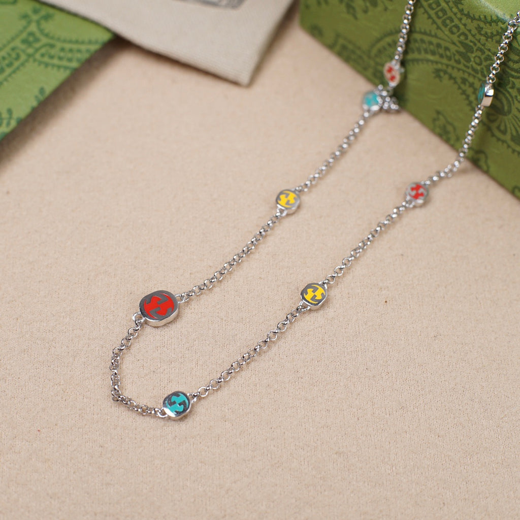 Gucci charm bracelet pair with silver chain and multicolor enamel link charms