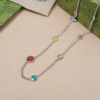 Gucci charm bracelet pair with silver chain and multicolor enamel link charms