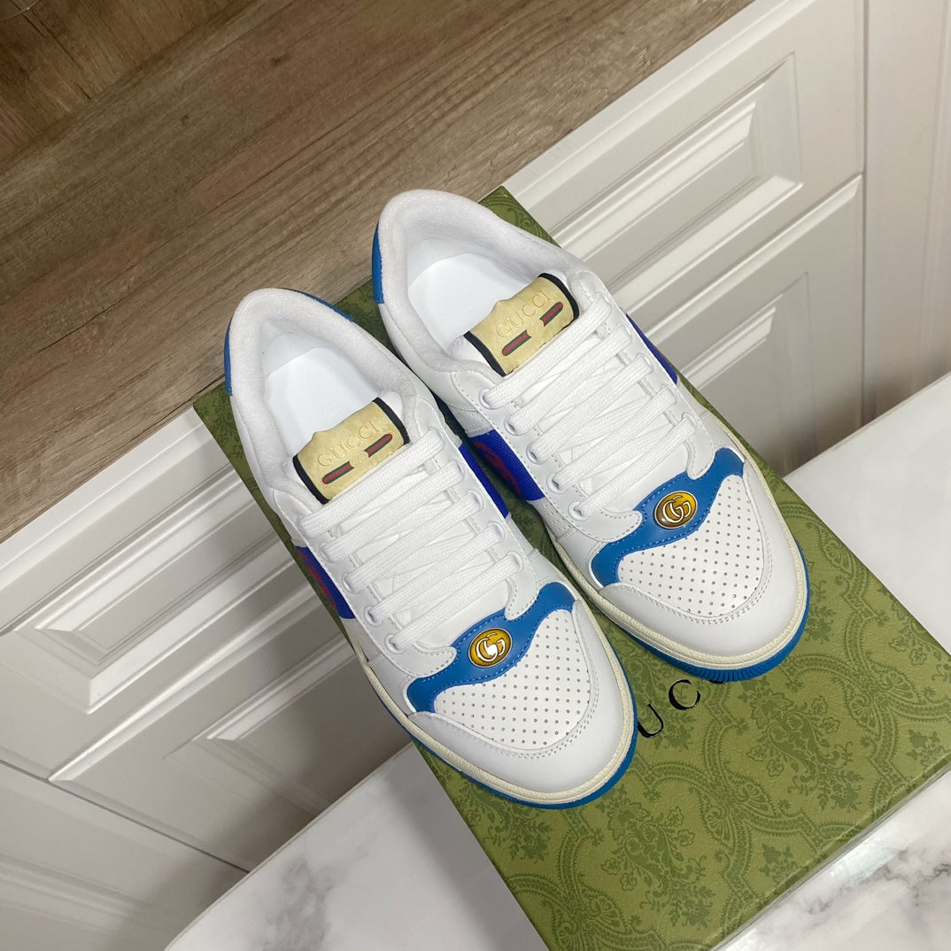 White and blue lace-up low-top sneakers with perforated toe and gold heel pull tabs