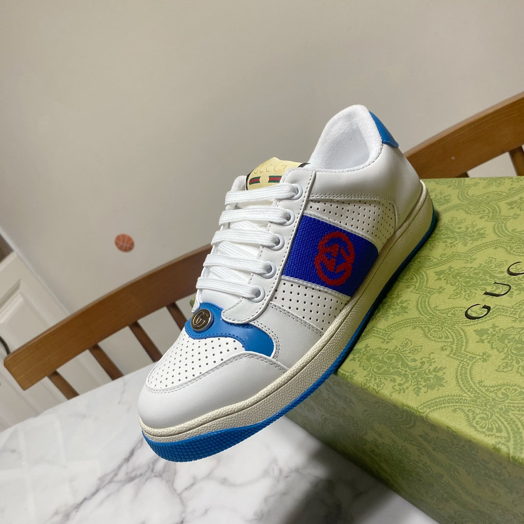 White and blue lace-up sneakers with red logo patch and textured blue trim