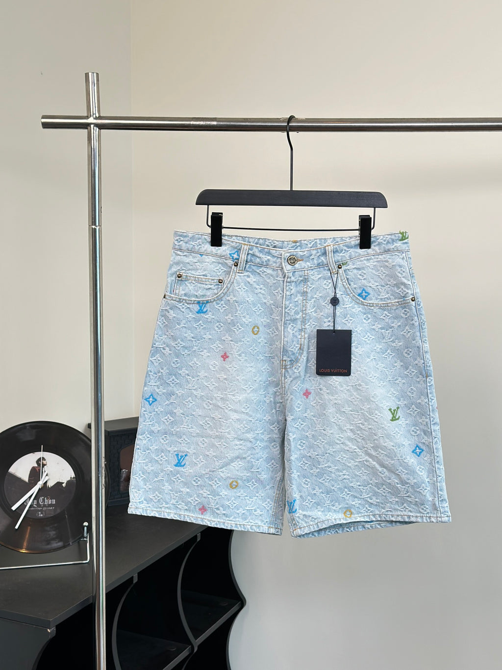 Light blue monogram denim shorts with front button and zipper closure