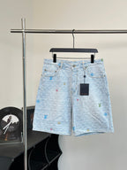 Light blue monogram denim shorts with front button and zipper closure