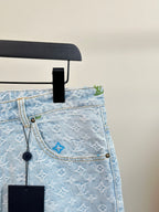 Light blue monogram denim shorts waistband close-up with hanging tag