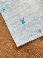 Light blue monogram denim shorts hem with blue and multicolor logo prints