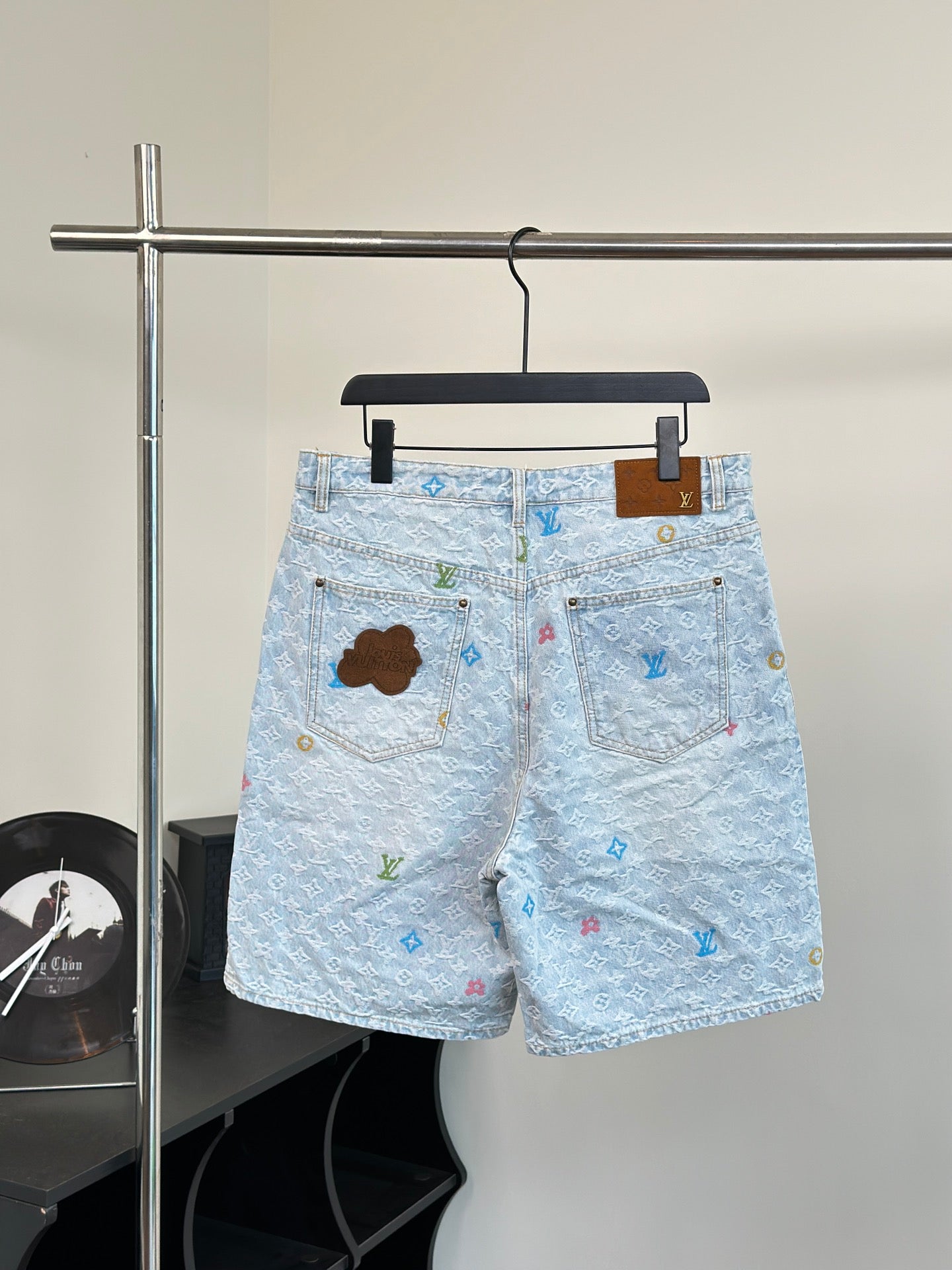 Light blue monogram denim shorts with front fly and patch pocket details