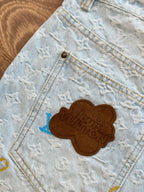 Light blue monogram denim shorts with brown embroidered bear patch on pocket