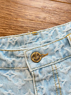 Light blue monogram denim shorts with round logo button and waistband tag