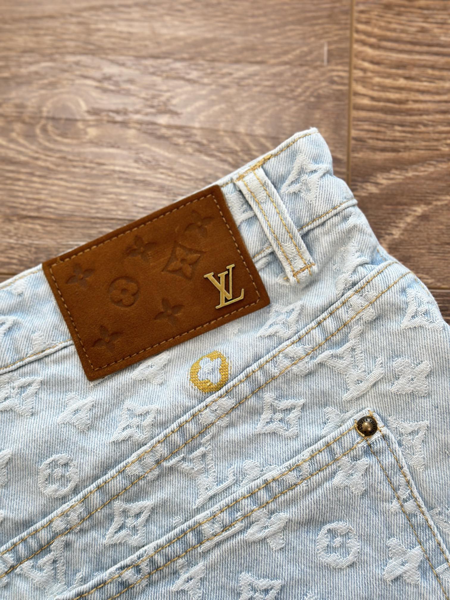 Light blue monogram denim shorts with brown LV leather waistband patch