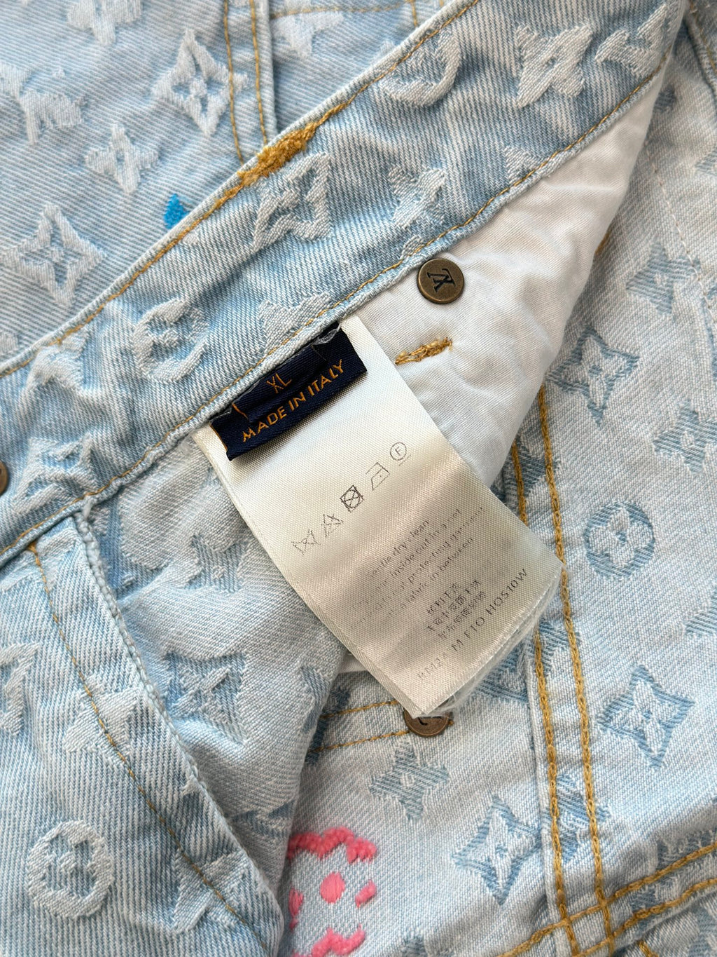 Light blue monogram denim shorts with inner care label and stitched waistband